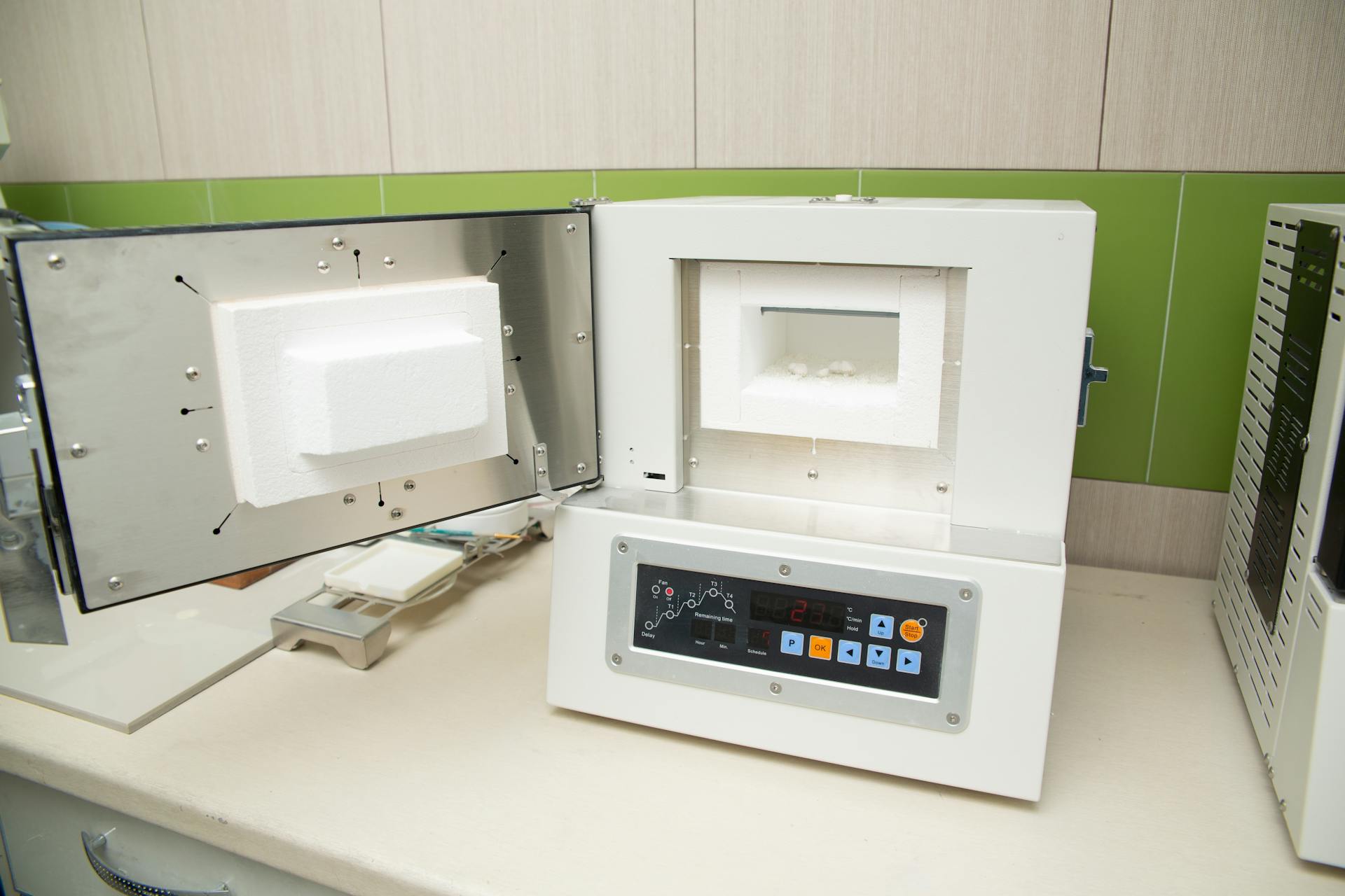 Interior of modern light dental clinic with white thermal oven with dental implants inside