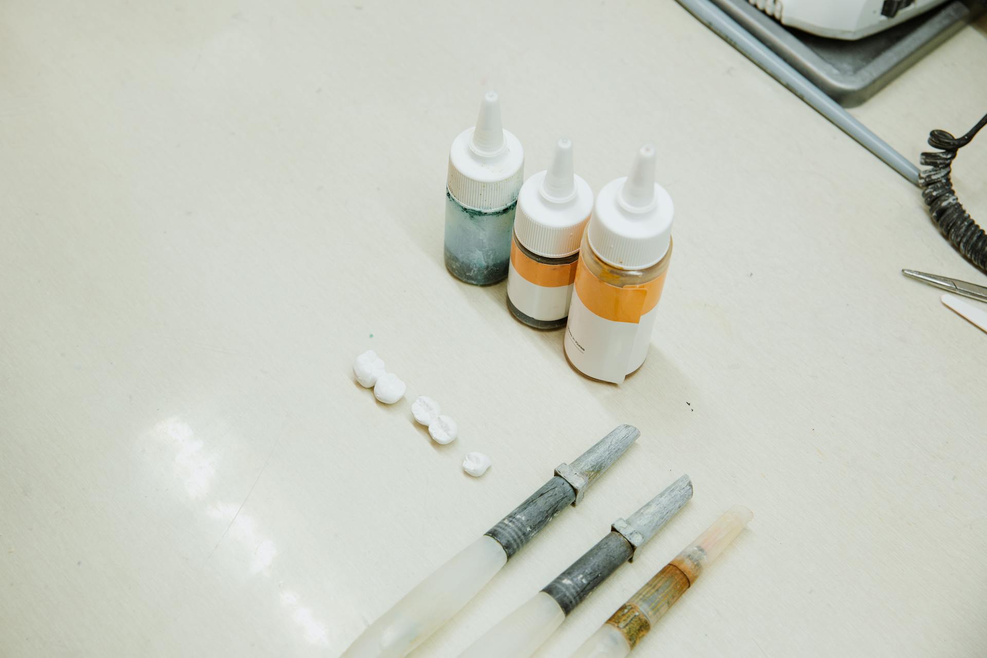 Set of dental implants near bottles and dental tools