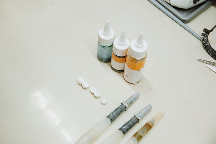 Set Of Dental Implants Near Bottles And Dental Tools