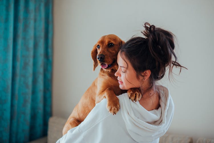 A Woman Carrying Her Dog