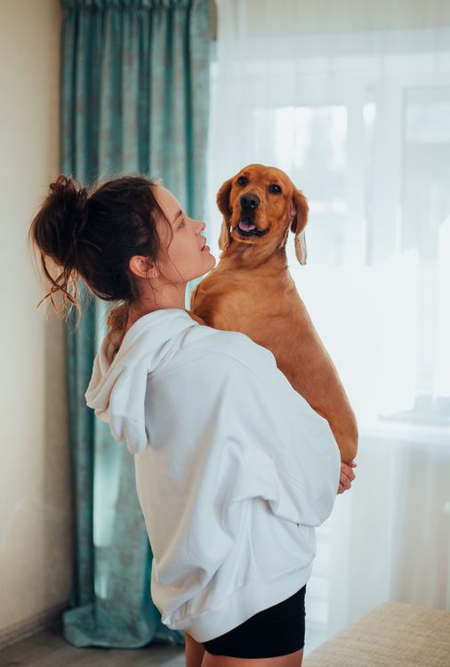 Pet owner with dog at home
