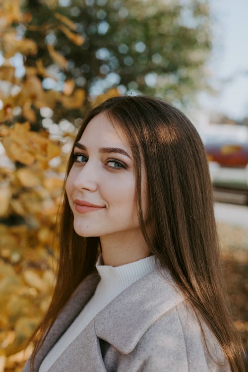 A Smiling Woman Wearing a Coat