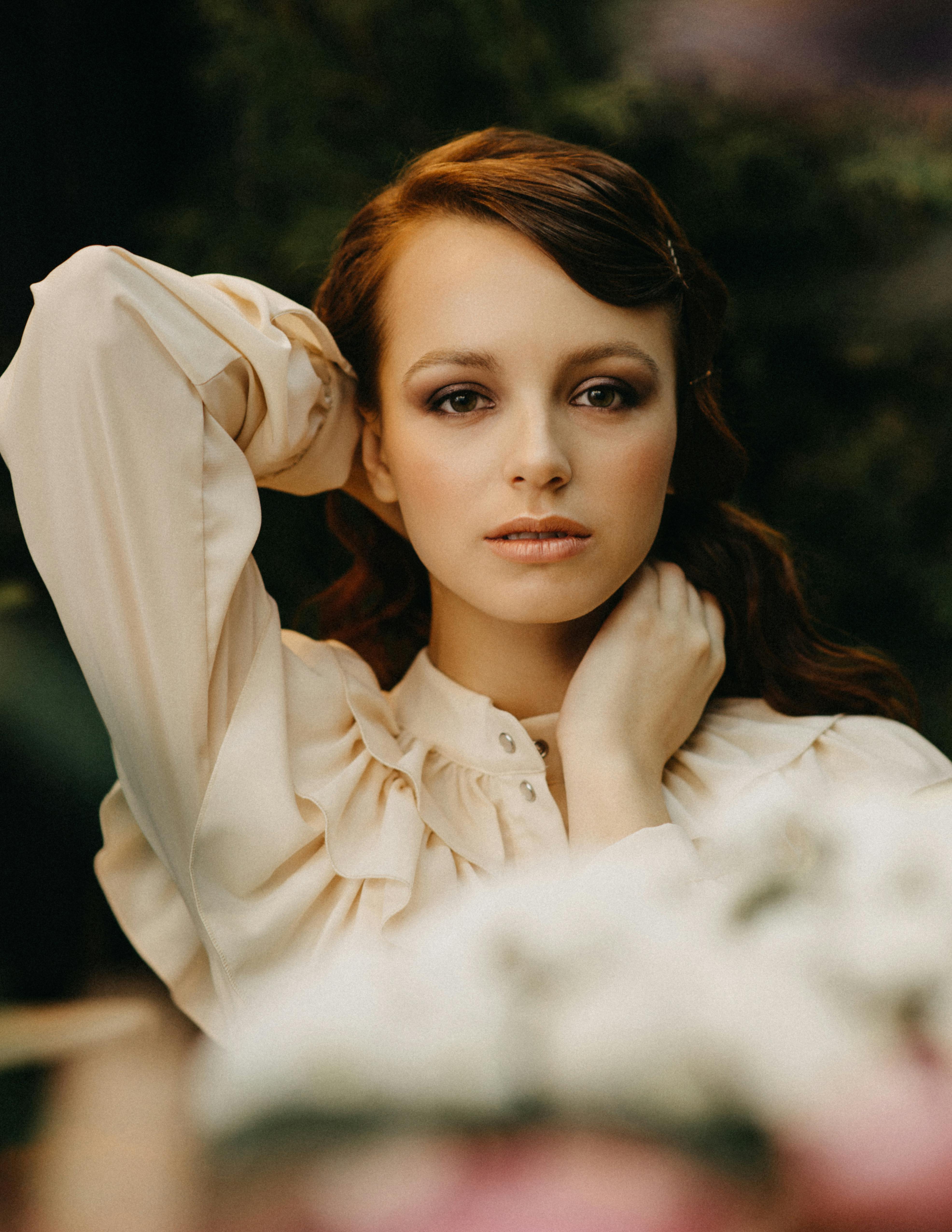 Captivating portrait of a woman posing outdoors, showcasing elegance and beauty.