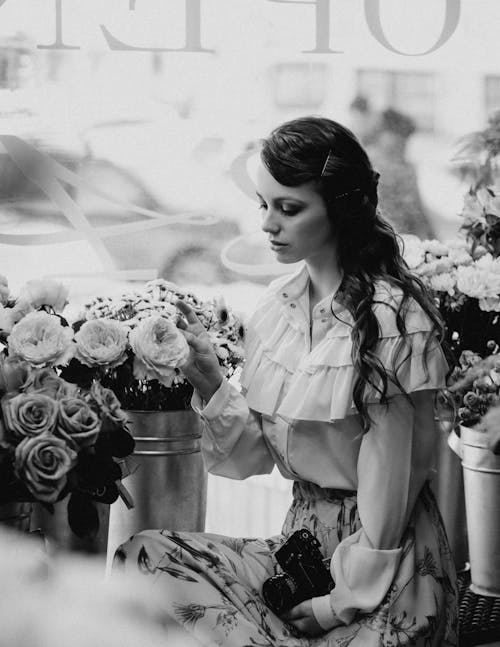 Woman in White Dress Shirt Holding Bouquet of Flowers