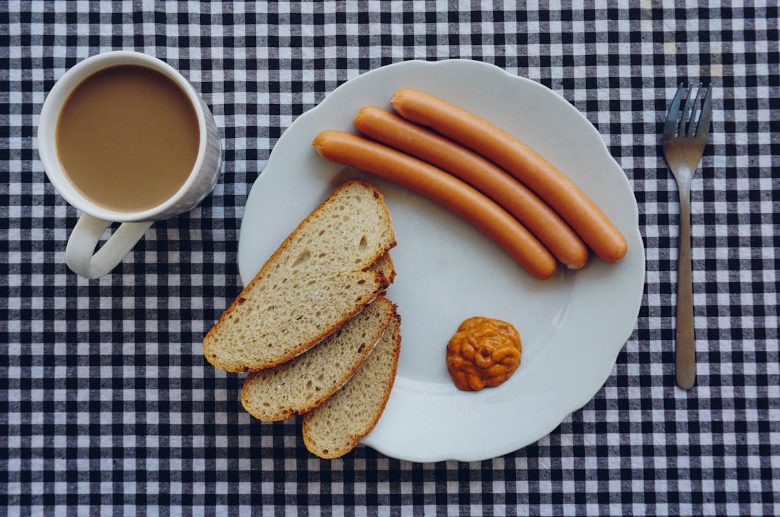 Free Sausages, Bread and Coffee on Table Stock Photo