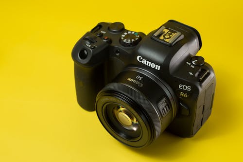 A Black Camera on a Yellow Surface