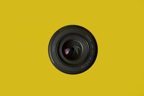 Camera Lens on Yellow Background