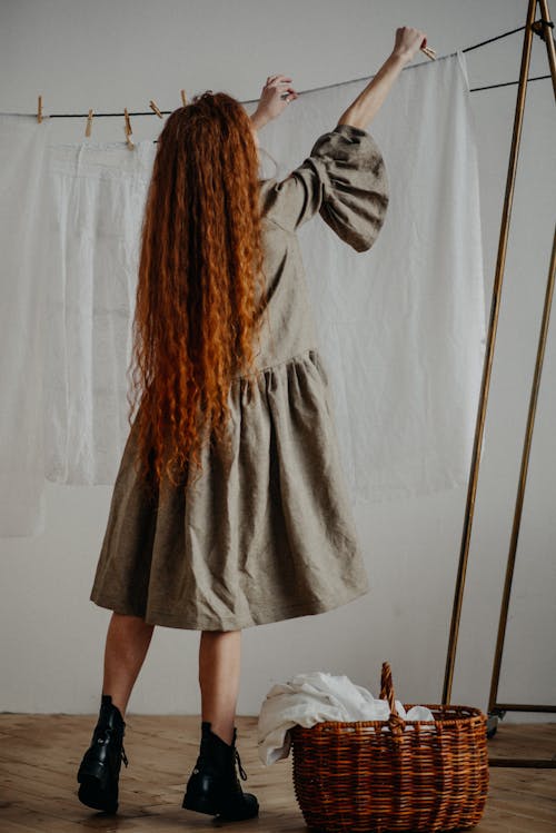 Woman in a Dress Hanging Linens
