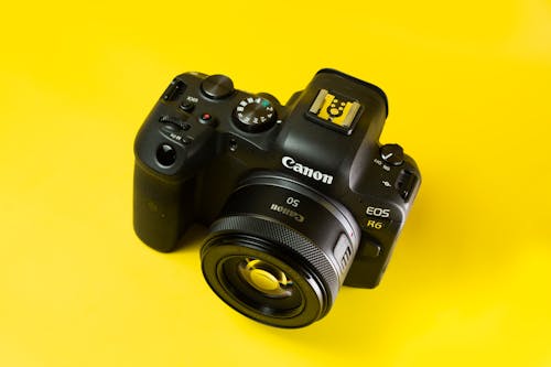 A Branded Digital Camera on a Yellow Surface 