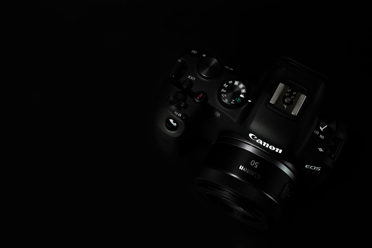 close up of a digital camera against a black background showcasing pho