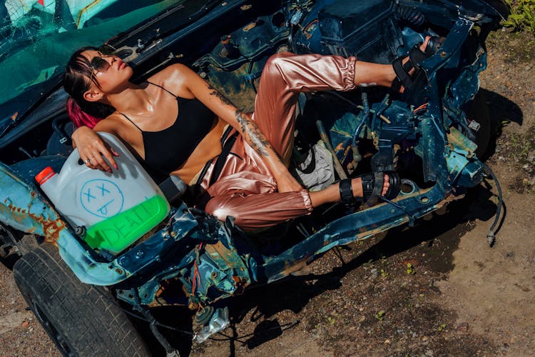 Woman Posing On A Crashed Car 