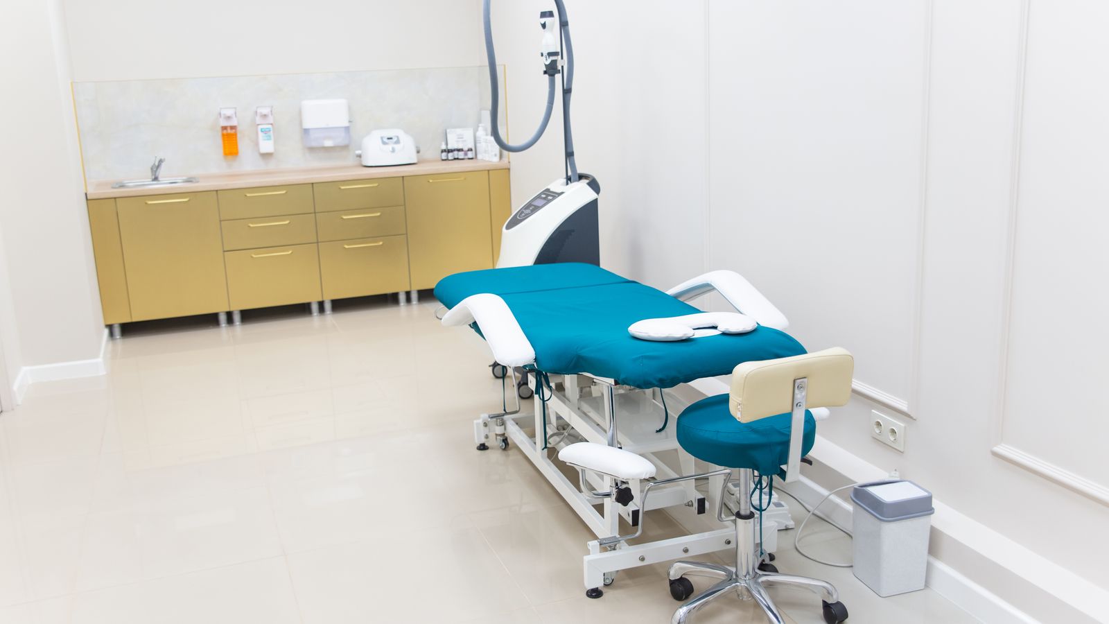 Clean and modern medical examination room with equipment ready for use.