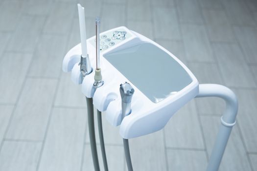 Close-up of high-tech dental tools in a clean, bright clinic.