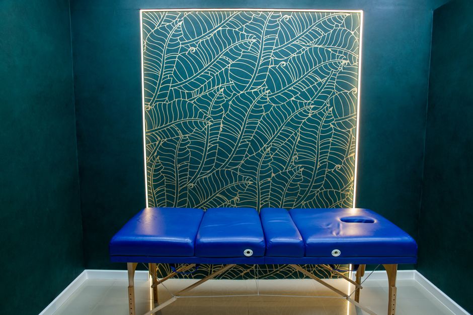 A serene spa room setting with a treatment bed and neatly folded towels. - anal bleaching A serene spa room setting with a treatment bed and neatly folded towels. - anal bleaching