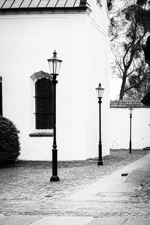 Free A classic black and white image of street lamps and cobblestones in Gdańsk, Poland. Stock Photo