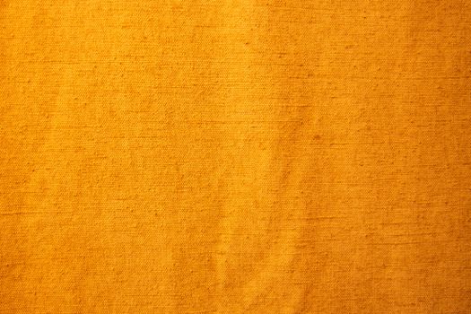 Detailed view of yellow textile fabric showcasing its texture and pattern.