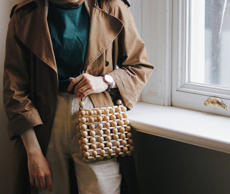 Crop Stylish Woman With Handbag Against Window