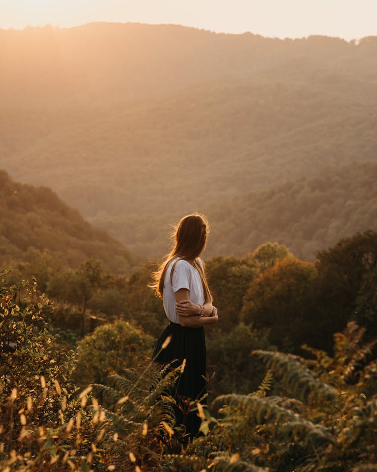 Woman Standing In Mountainous Valley