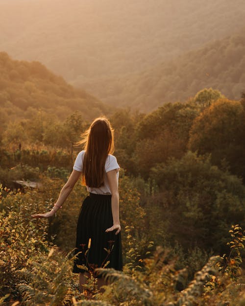 Woman standing on grassy hill