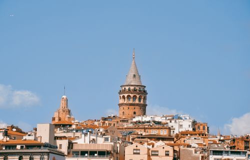 Free View of historic Galata Tower and Istanbul skyline against a clear blue sky. Stock Photo