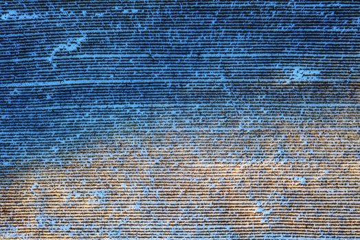 Aerial view of snow-dusted farm fields with linear patterns, creating a striking winter scene.