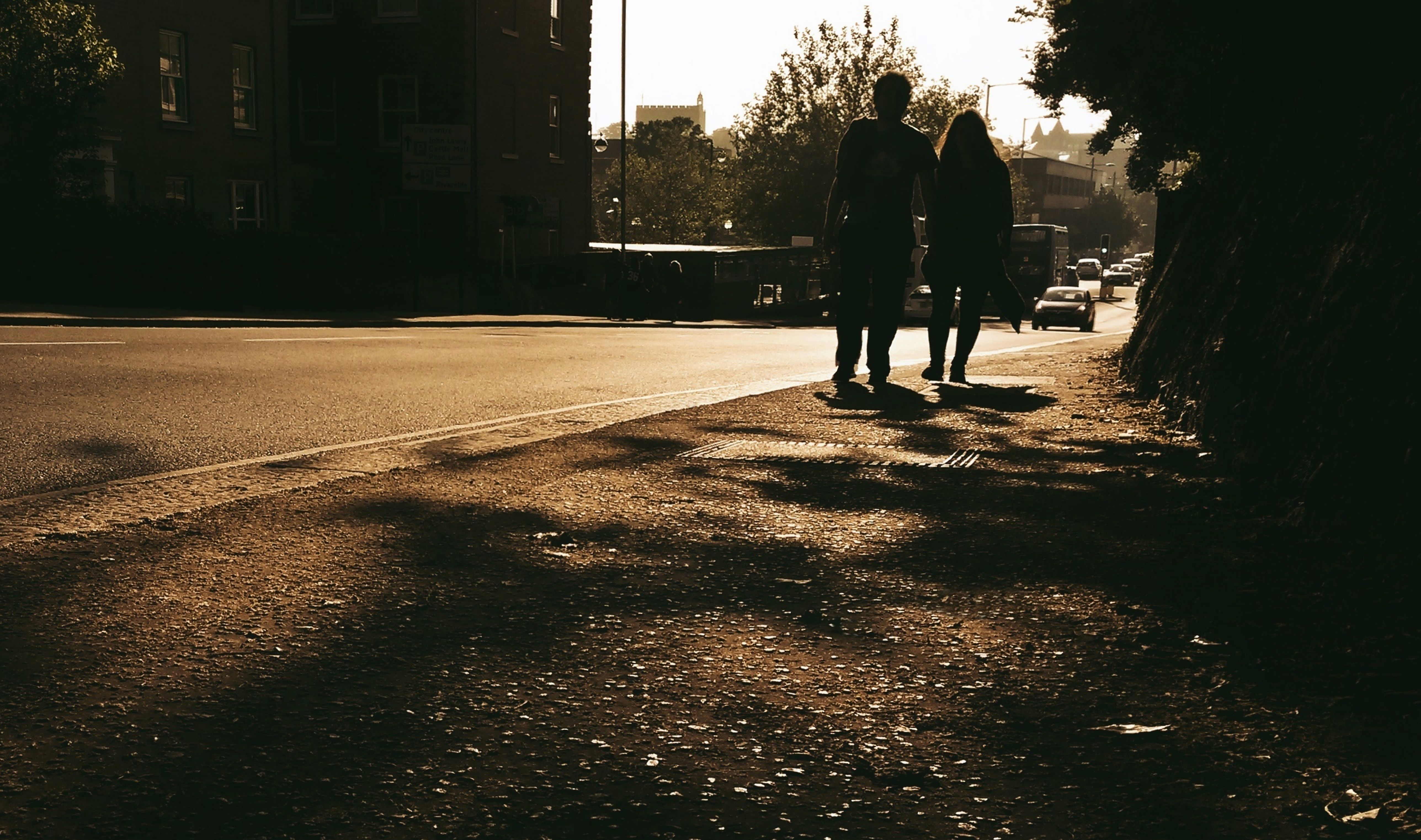 Silhouette of a Couple Walking on the Sidewalk · Free Stock Photo