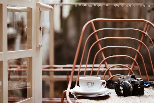 An inviting vintage café setup featuring a hot drink and an Olympus camera.