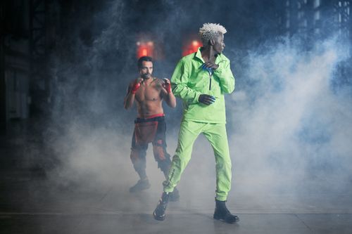 Free Two dancers perform energetically with fog effects creating a dramatic atmosphere. Stock Photo