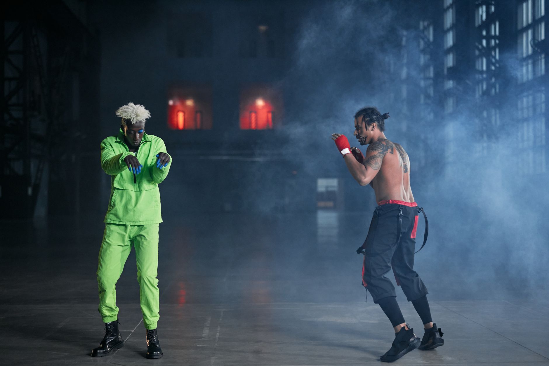 How Martial Arts Helps Kids Handle Peer Pressure and Build Confidence 5 Two martial artists engage in a dynamic showdown amidst dramatic smoke on stage.