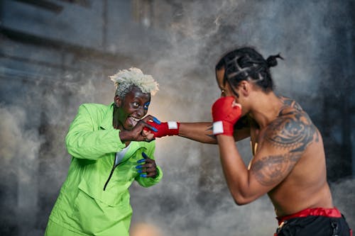 Free Two Men Fighting while Wearing Their Game Character Costumes Stock Photo
