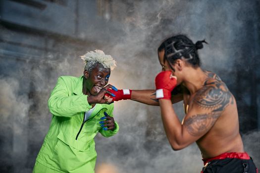 Intense moment of two cosplayers engaged in a dramatic fighting scene.