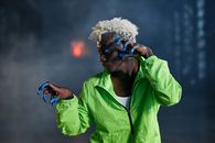 Woman in Green Zip Up Jacket Wearing Black Sunglasses