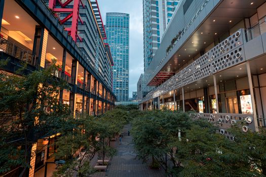 Contemporary architectural alley with skyscrapers and trees in Taipei, Taiwan.