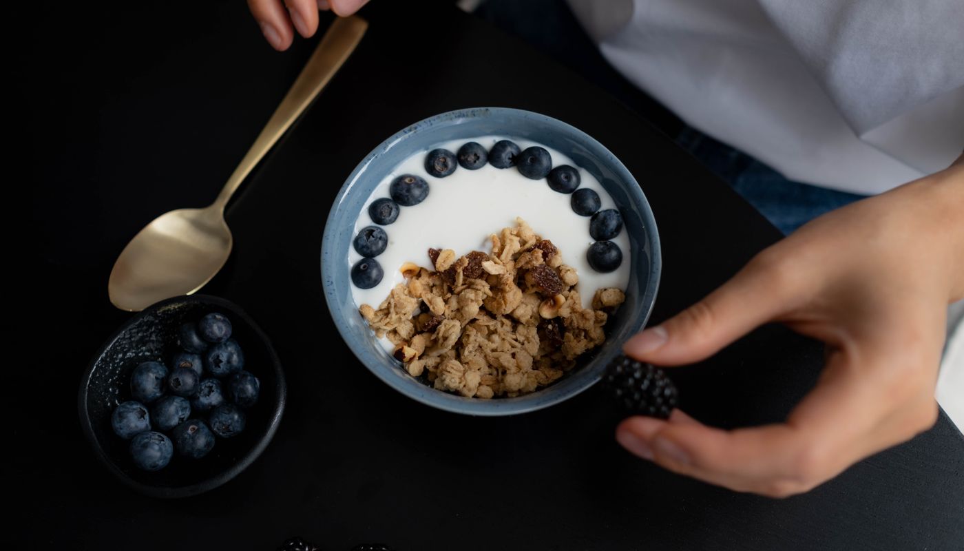 counting snack calories — Bowl with Granola, Milk and Blueberries on Black Table · Free. Photo: Pexels