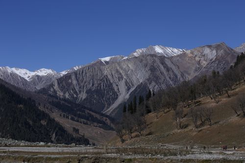 Free Captivating view of snow-capped mountains in Gulmarg under a clear blue sky. Stock Photo