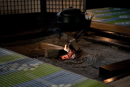 A traditional Japanese irori with kettle over a small fire, creating a warm and cozy atmosphere.
