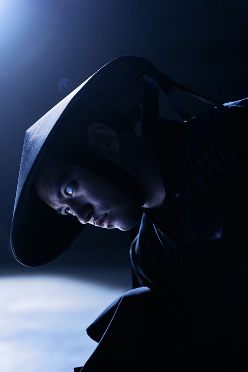 Free Mysterious man wearing a conical hat in dramatic lighting Stock Photo