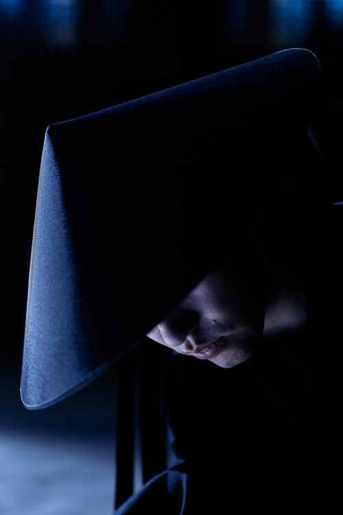 Free A moody, side-lit portrait of a character wearing a sakkat hat, capturing a mysterious and conceptual essence. Stock Photo