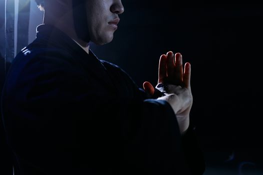 Captivating studio shot of martial artist in traditional attire, embodying focus and discipline.