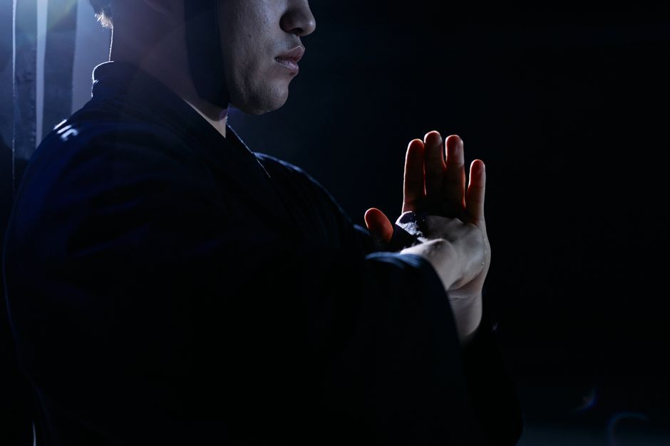 Captivating studio shot of martial artist in traditional attire, embodying focus and discipline.
