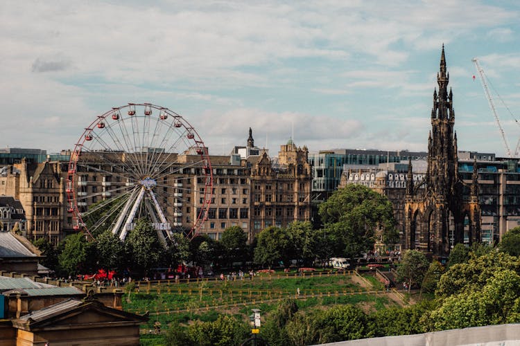 Photo Of The Ferris Wheel And The Scott Monument In Edinburgh, Scotland, UK 