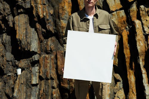 A Person Holding White Blank Paper