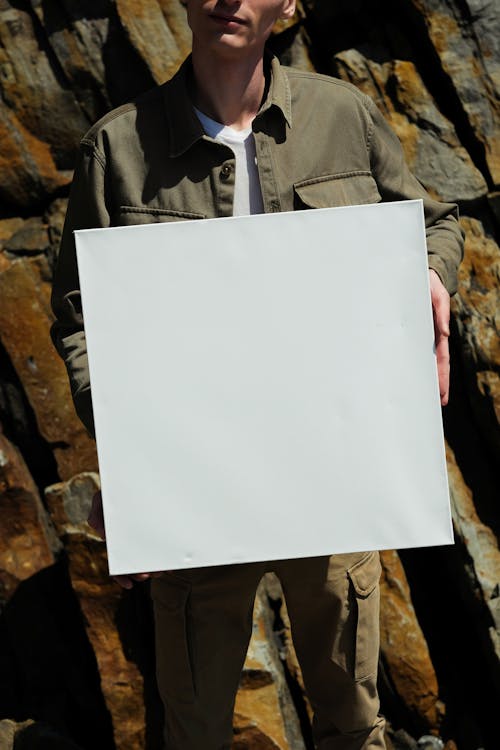 A Person Holding a White Blank Paper