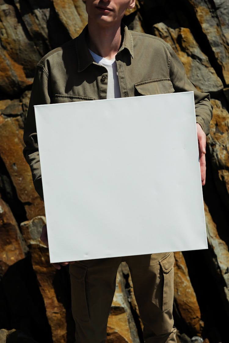 A Person Holding A White Blank Paper