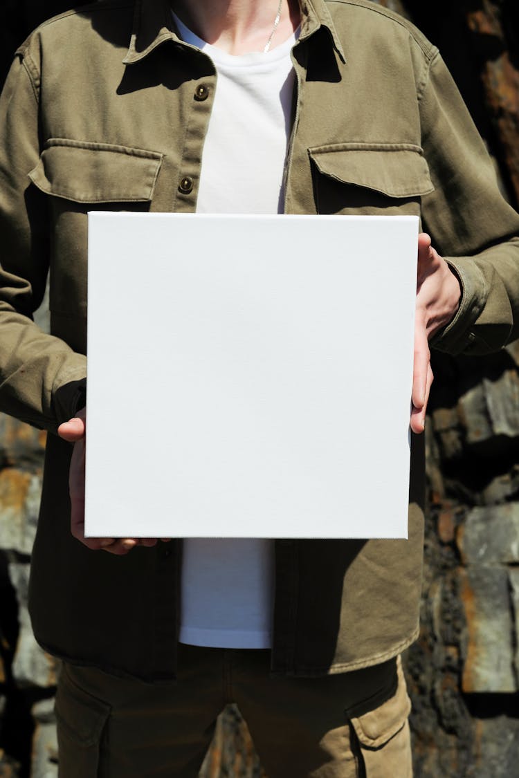 Man Holding White Square Box