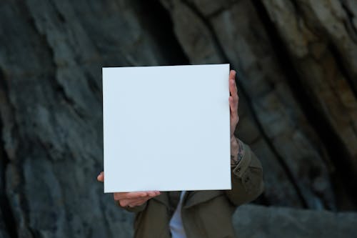 A Person Holding White Printer Paper