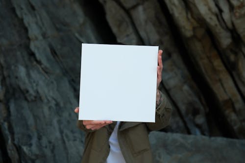 A Person Holding White Printer Paper