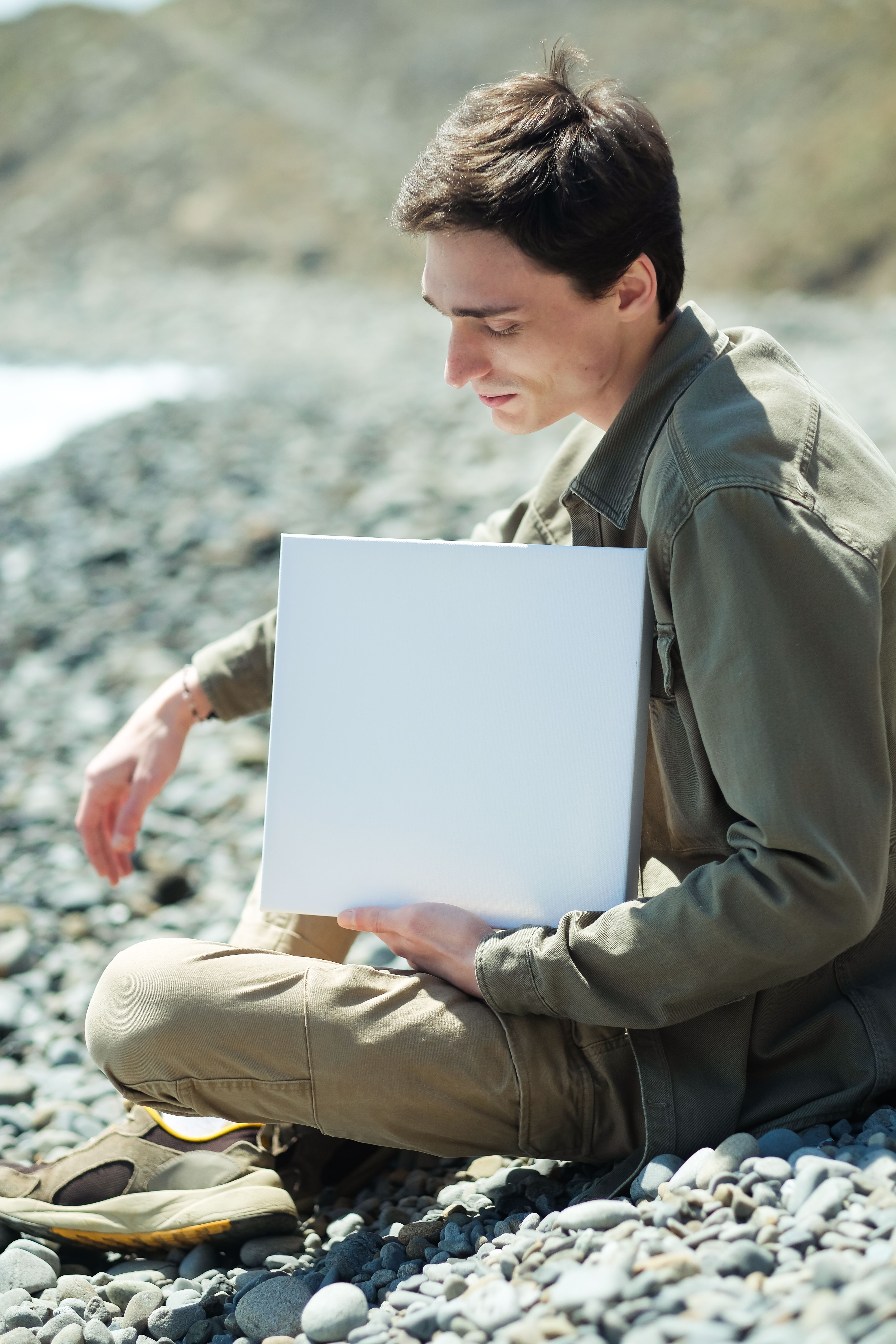 A Man Wearing Jacket Sleeping on the Rocky Ground · Free Stock Photo