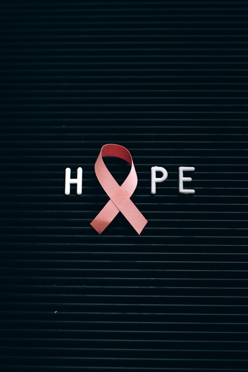 Free A Pink Ribbon on a Letter Board with Message Stock Photo