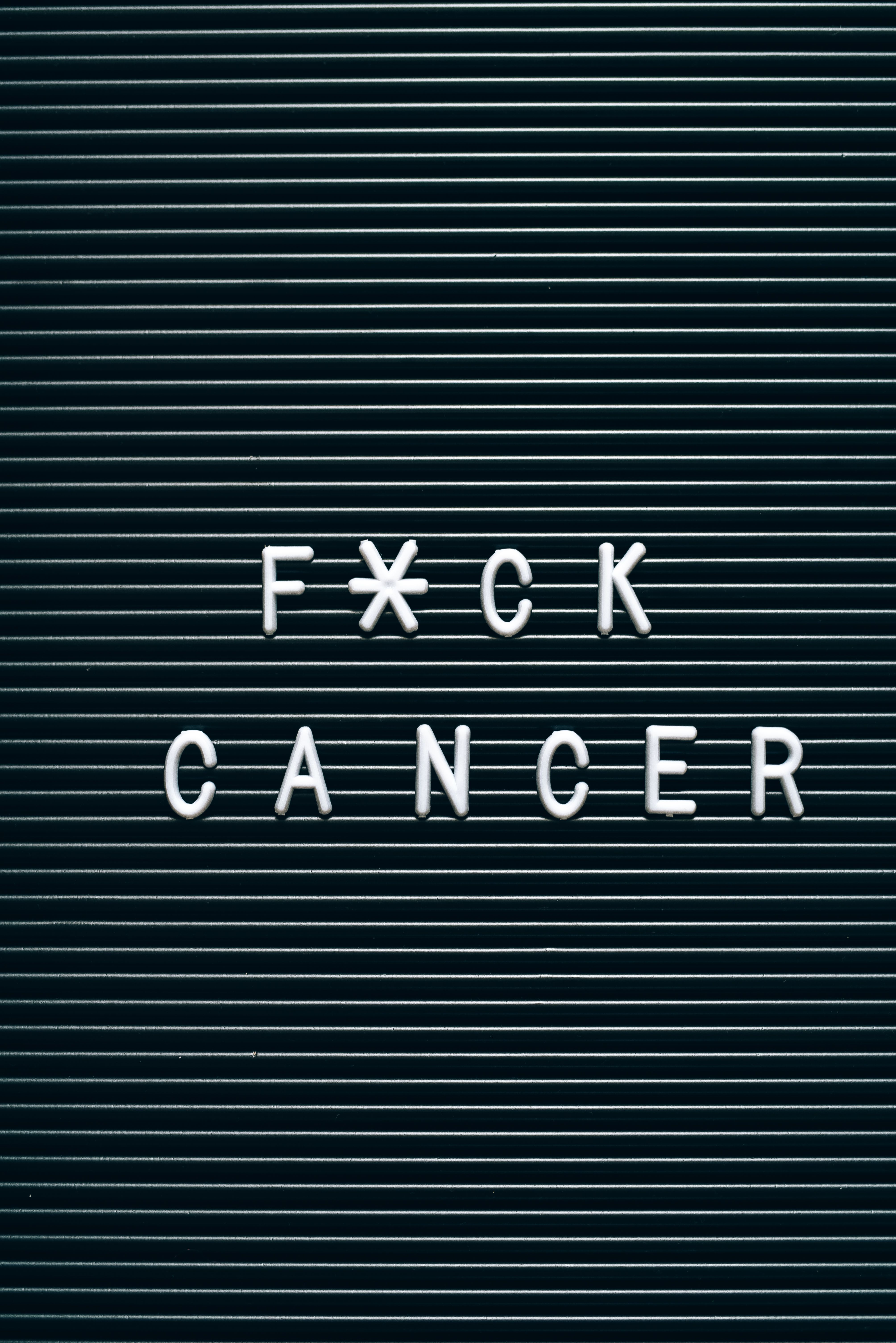 A strong cancer awareness message on a letter board promoting empowerment and resilience.